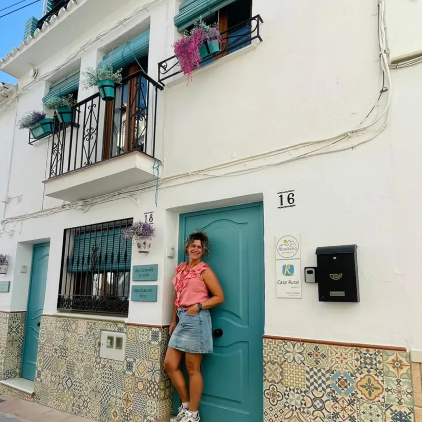 Anouk van den Berg stands in front of her authentic Casa de la Montaña in Sayalonga, Malaga.
